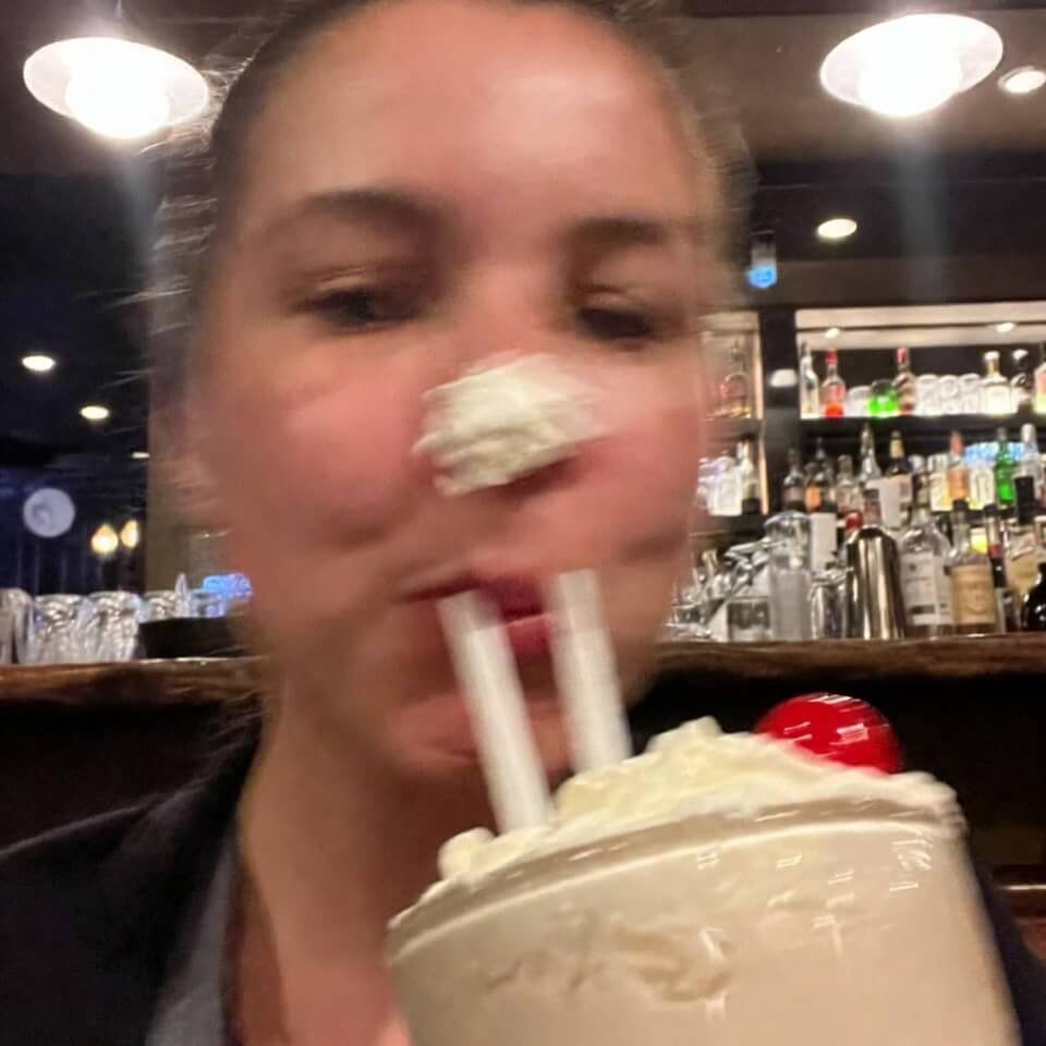 Blurry selfie with whipped cream on nose, oversized milkshake