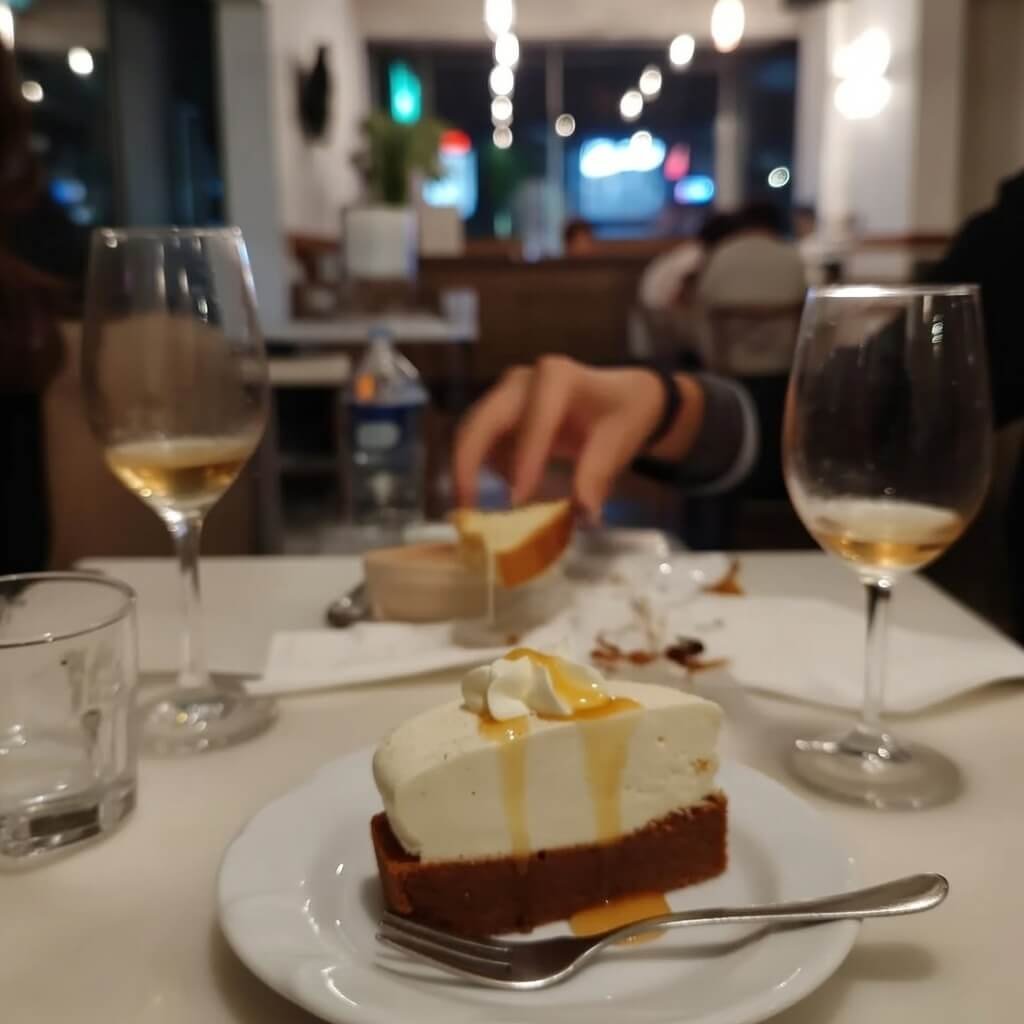 Blurry POV of spilled wine and reaching hand grabbing bread